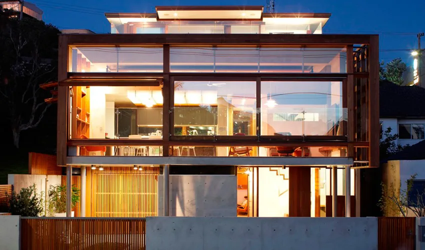 Glazed home lit from within at dusk